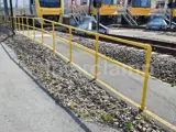 Yellow powder coated safety handrails by train station